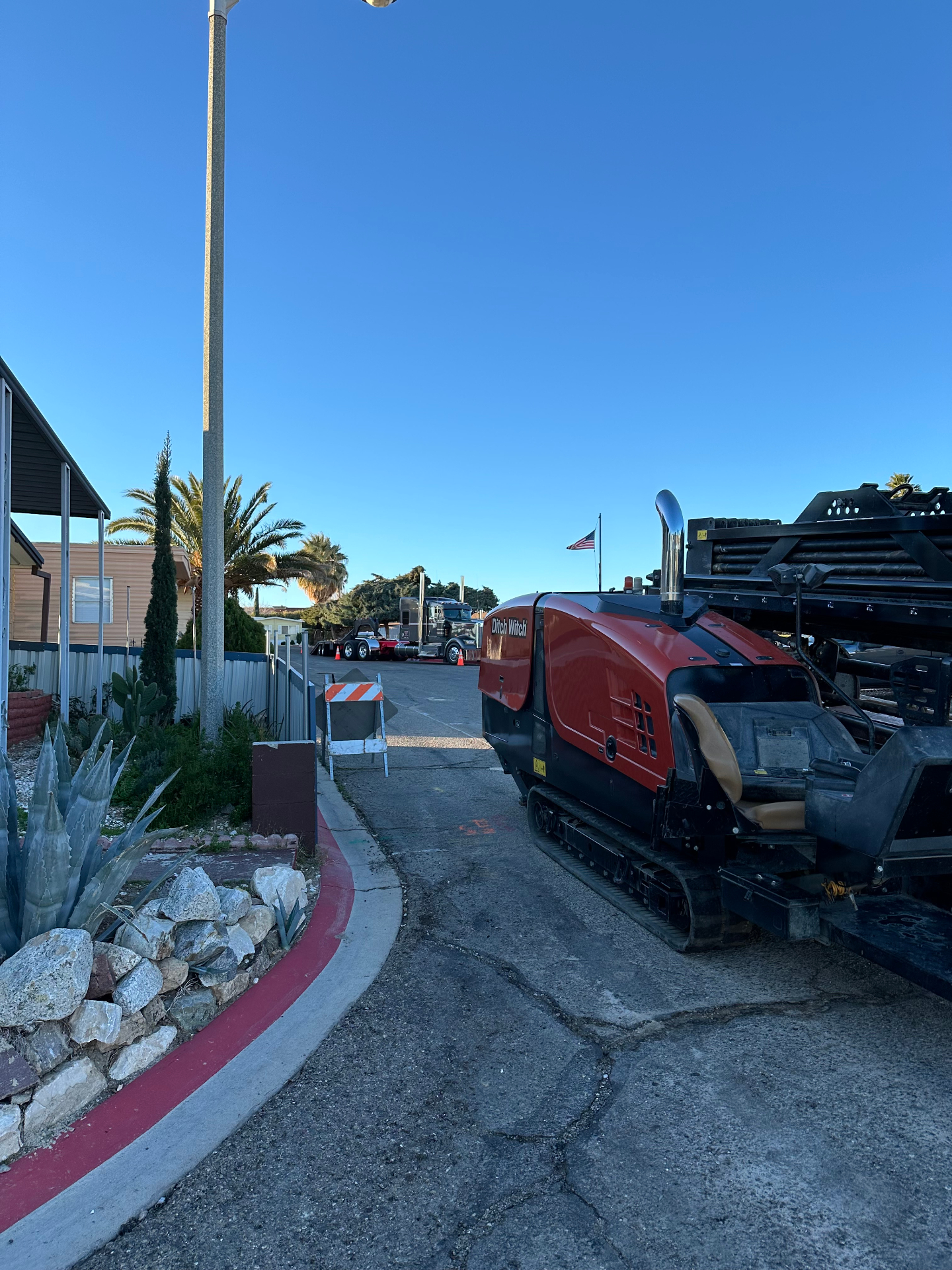 Rig staged at a mobile home park entrance in the High Desert